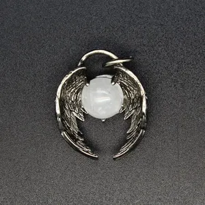 Close-up of crystal bead angel wing pendant made of natural stone and antique silver