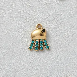 Macro view of gold-plated octopus charm inlaid with blue cubic zirconia stones for DIY jewelry