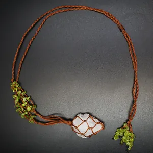 Detail view of Bohemian handmade woven necklace featuring peridot and white crystal raw stone