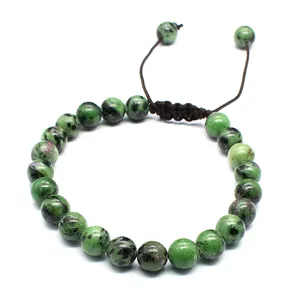 Close-up of 8mm Ruby Zoisite stone beads on a handmade braided adjustable bracelet