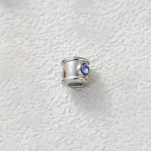 Detail shot of stainless steel spacer bead with inset blue zircon for DIY jewelry.