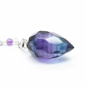 Close-up detail of a natural faceted fluorite crystal pendant showing purple and blue hues