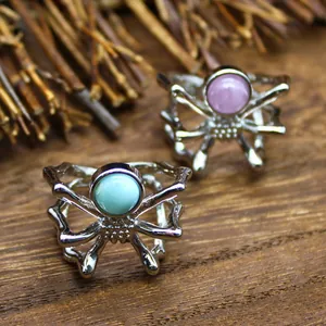 Detailed view of silver spider open rings with blue and purple natural gemstones.