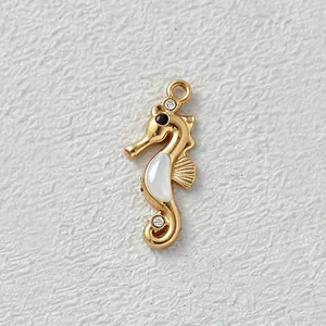 Detailed view of a gold-plated seahorse pendant with white shell inlay and zirconia.
