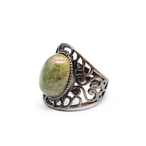 Close-up view of a vintage hollow ring featuring a natural oval unakite green gemstone.