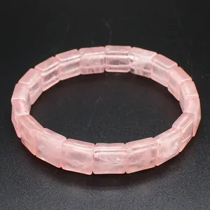 Macro view of a faceted square pink rose quartz bracelet with translucent tile texture.