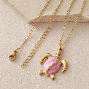 Gold plated stainless steel turtle necklace with pink enamel dripping oil charm pendant.