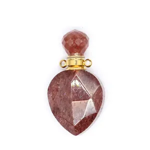 Detailed view of faceted red crystal perfume bottle pendant with gold hardware