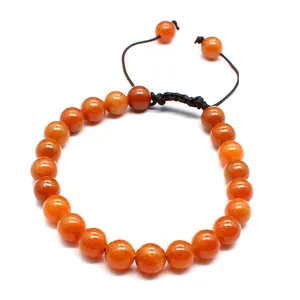 Close-up of 8mm orange natural stone beads on a black adjustable woven bracelet cord.