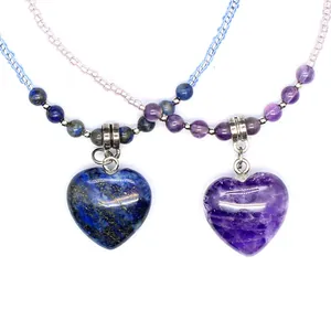 Close-up of natural heart-shaped amethyst and lapis lazuli pendants on beaded chains