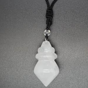 Detail of a white crystal conical pendant with a black braided cord on a grey background.