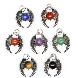 Detail view of seven natural stone angel wing pendants in a variety of vibrant colors