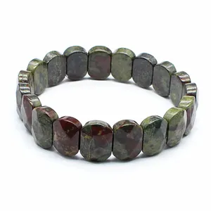 Detailed macro view of faceted natural dragon blood jasper stone beads on a stretch bracelet