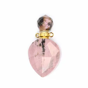 Detailed view of a faceted natural rhodonite teardrop perfume bottle pendant with gold accents
