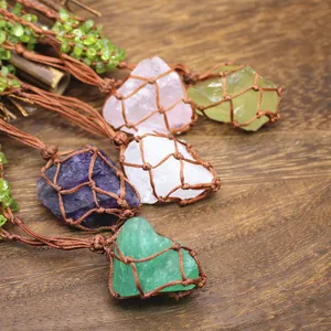 Close-up of raw natural crystal stones wrapped in brown vintage braided net pouches