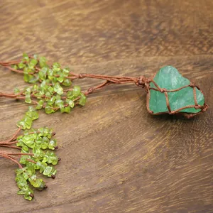 Close-up of bohemian woven necklace with green fluorite raw stone and peridot chips