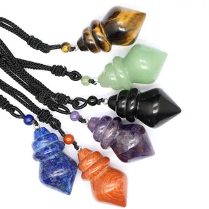 Close-up of various gemstone cone-shaped pendants showing natural textures and colors