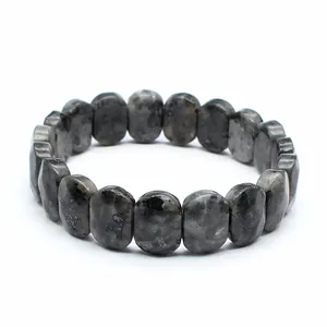 Close-up detail of a natural grey speckled stone faceted bead stretch bracelet for women.