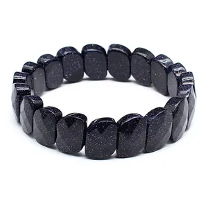 Macro detail of dark blue sandstone faceted bracelet showing shimmering particles