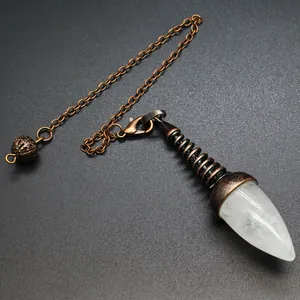 Detailed macro shot of a white crystal dowsing pendulum with an antique bronze metal chain.