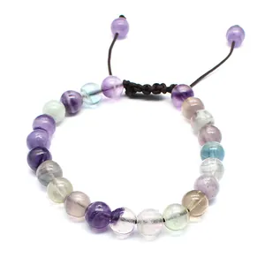 Detailed view of 8mm natural fluorite beads on a brown hand-woven adjustable cord.