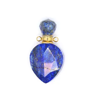 Macro view of a faceted lapis lazuli perfume bottle pendant with gold loops