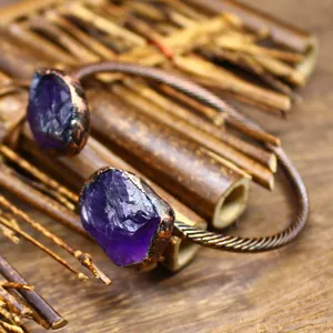 Close-up of vintage raw purple crystal stones on a twisted metal open cuff bracelet