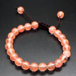 Handmade 8mm natural orange stone bead bracelet featuring an adjustable woven cord closure