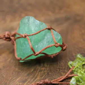 Macro detail view of natural green fluorite raw stone in hand-woven retro mesh cord bag