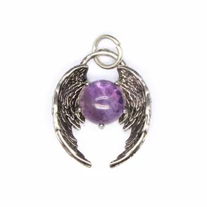 Close-up detail of natural amethyst bead angel wing pendant showing fine feather engraving