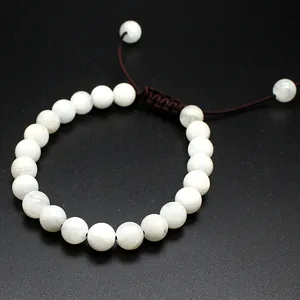 Detailed view of white 8mm natural stone bead bracelet with adjustable woven cord