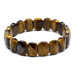 Detail view of a faceted natural tiger's eye stone stretch bracelet on a white background.