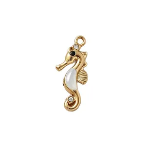 Gold plated stainless steel seahorse pendant with white inlay and clear cubic zirconia.