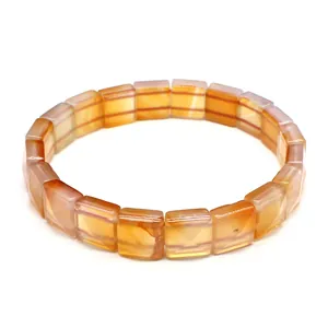 Close-up of faceted square-cut natural yellow agate stones on a stretch beaded bracelet