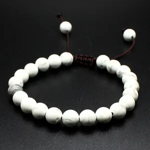 Macro detail of a handmade 8mm white natural stone bead bracelet with adjustable cord.