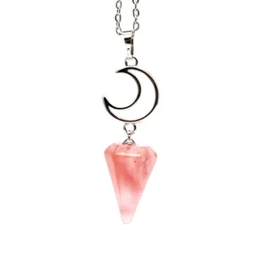 Detail shot of a natural pink crystal hexagonal cone pendant on a silver moon necklace