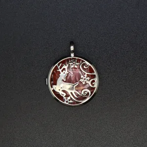 Close-up of a silver reindeer locket pendant featuring a faceted rose quartz stone.