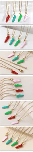 Macro view of gold-plated stainless steel necklaces with colorful soccer shoe pendants
