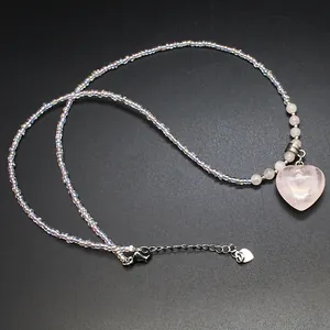 Elegant heart-shaped pink stone pendant necklace with clear acrylic bead chain.
