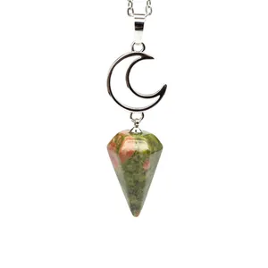 Macro detail of unakite hexagonal cone pendant hanging from a silver moon necklace