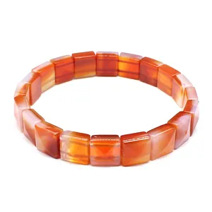 Detailed view of square faceted natural carnelian stone beads on a minimal stretch bracelet