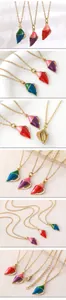 Detailed view of colorful enamel conch pendants on gold-plated stainless steel chains