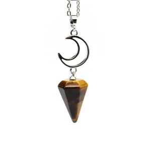 Macro view of natural Tiger's Eye hexagonal cone pendant with a silver crescent moon