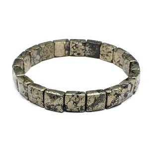 Close-up of a minimalist square-cut natural stone bracelet with metallic pyrite texture
