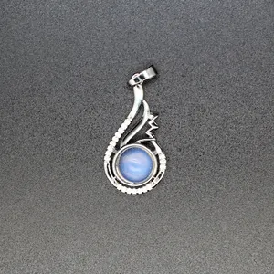 Close-up detail of silver-toned swan pendant featuring a blue cabochon and crystal accents