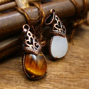 Detailed close-up of vintage water-drop pendants with natural stones and bronze filigree