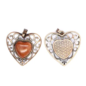 Front and back detail of a retro hollow heart pendant with sparkling brown goldstone