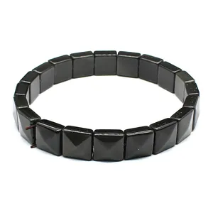 Close-up of black square faceted natural stone bracelet with pyramid texture details