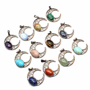 Detailed view of antique hollow crescent moon pendants with various colored natural stones.