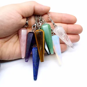 Close-up of assorted natural stone hexagonal cone chakra pendulums with silver chains